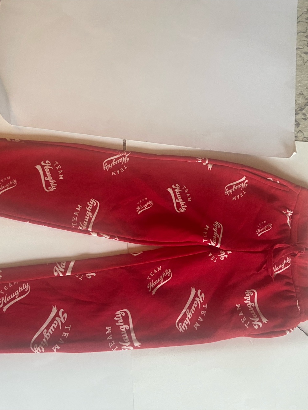 Team Naughty Women’s Size XS  Red and White Holiday Fleece Pajama Bottoms.